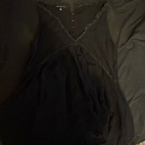 Its a tank top with a flurry bottom and with buttons on the back